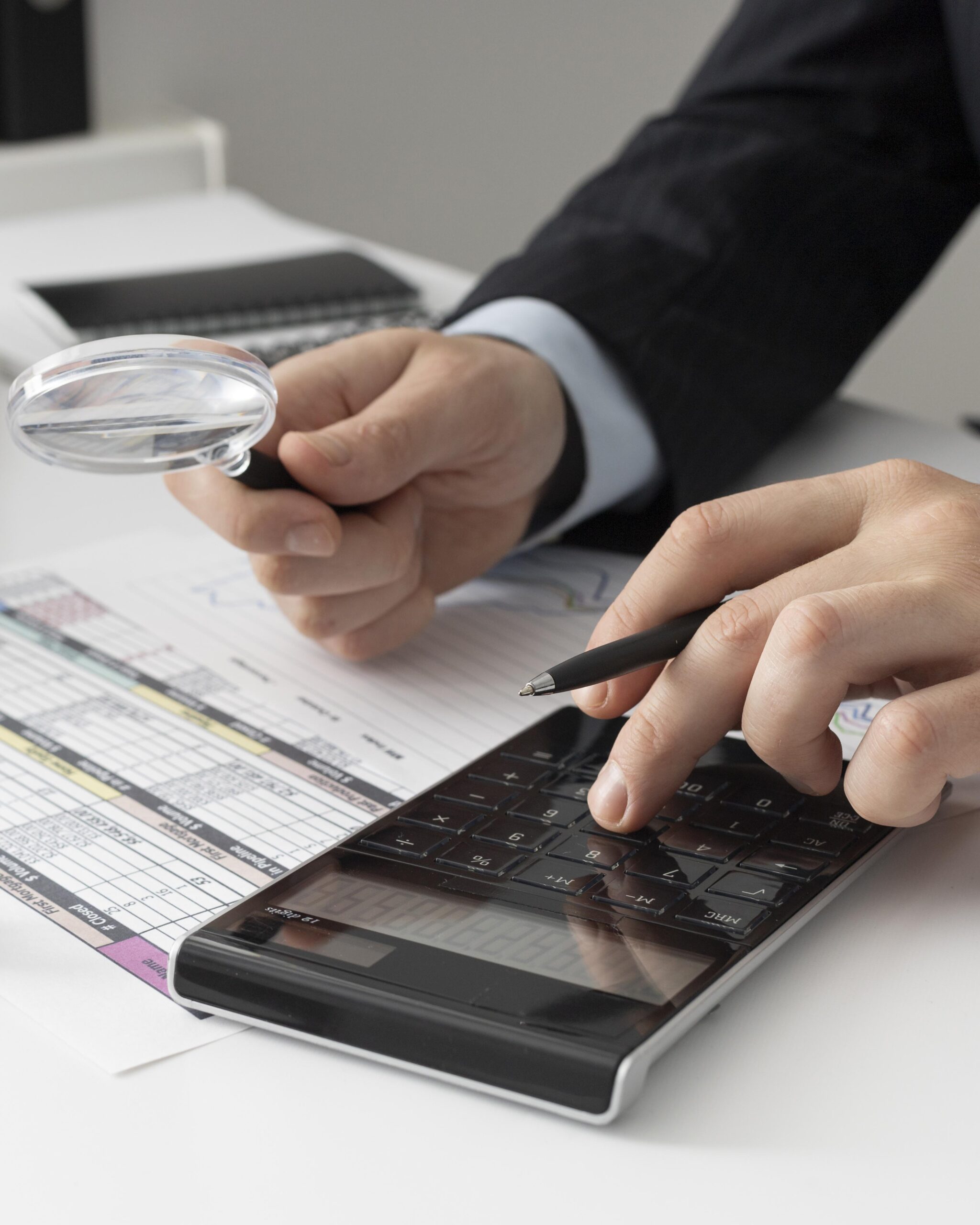 business man calculating finance numbers scaled