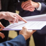 cropped view businesswomen reading document