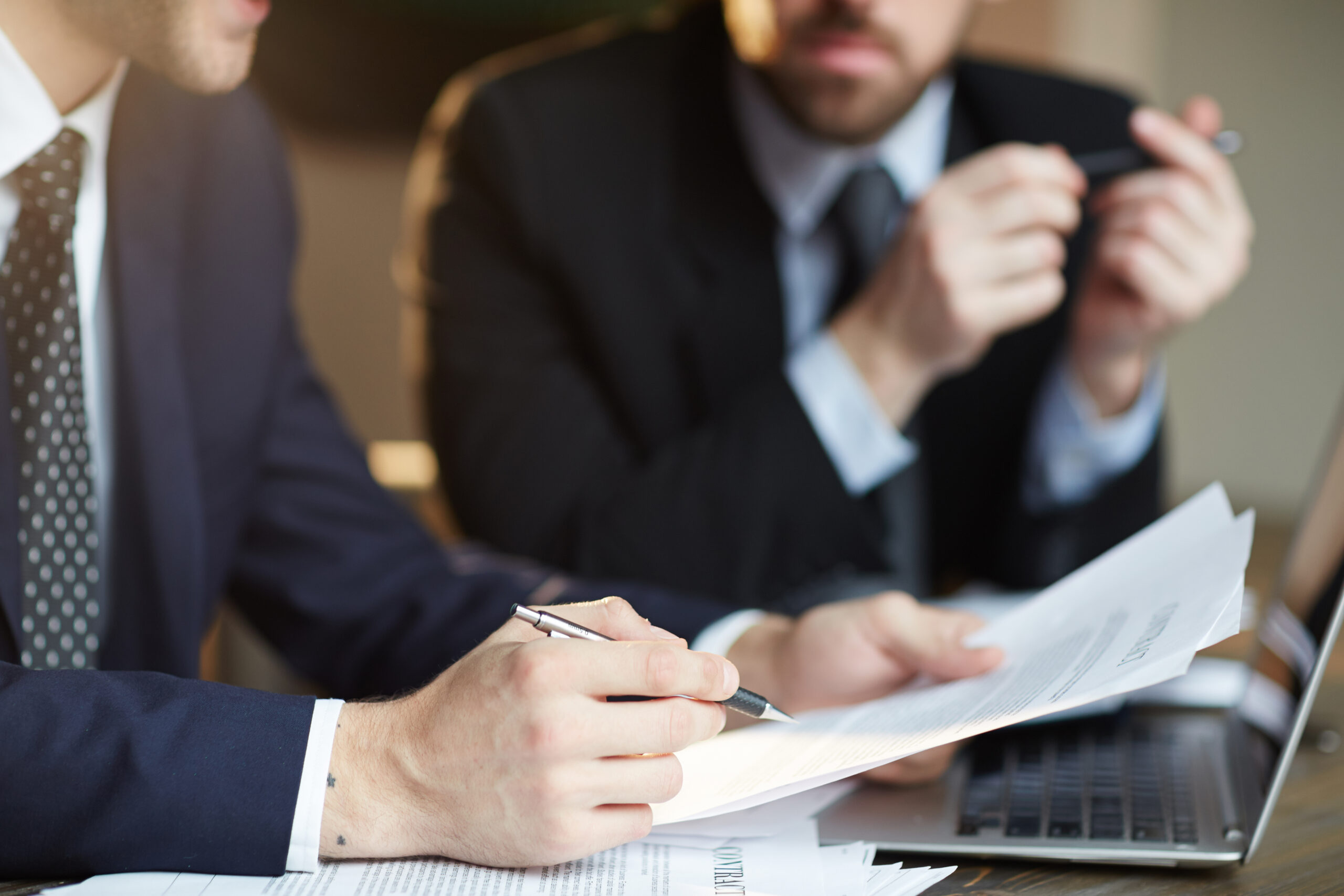 successful business partners discussing contract scaled