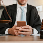 judge hands professional man typing communication networking texting legal contact law firm consultant advocate government lawyer smartphone person reading attorney policy update