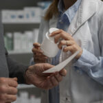 senior man consulting female pharmacist medication